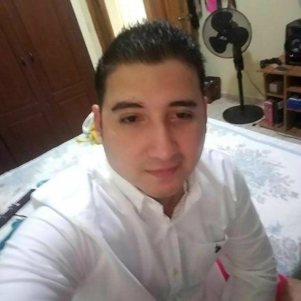 A selfie of Carlos Hernandez wearing a white Oxford shirt.